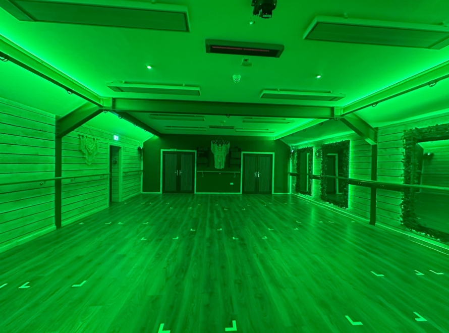 YogaLife’s wood-panelled studio with green lighting