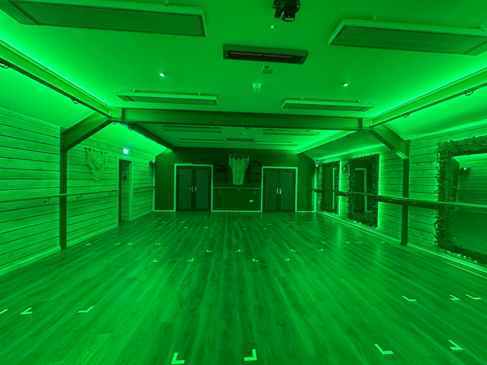 YogaLife’s wood-panelled studio with green lighting